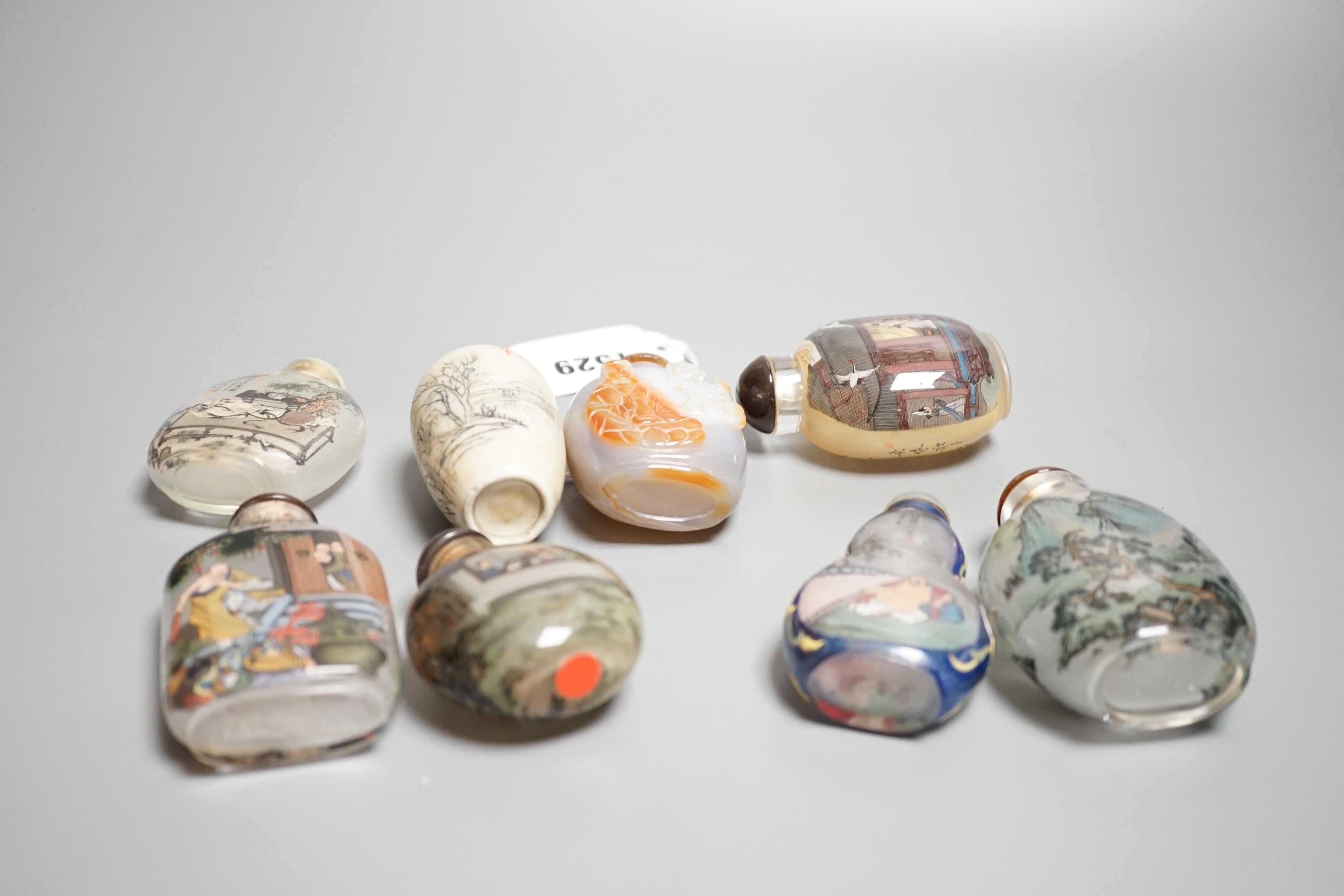 Six Chinese inside painted glass snuff bottles, an agate cameo snuff bottle and an incised crackle glaze snuff bottle, tallest 9cm